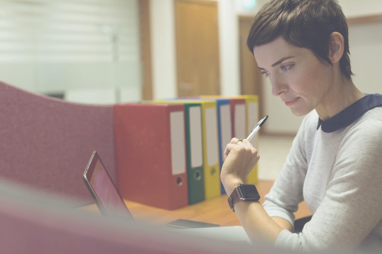 Business professional reviewing detailed financial charts and budget analysis reports